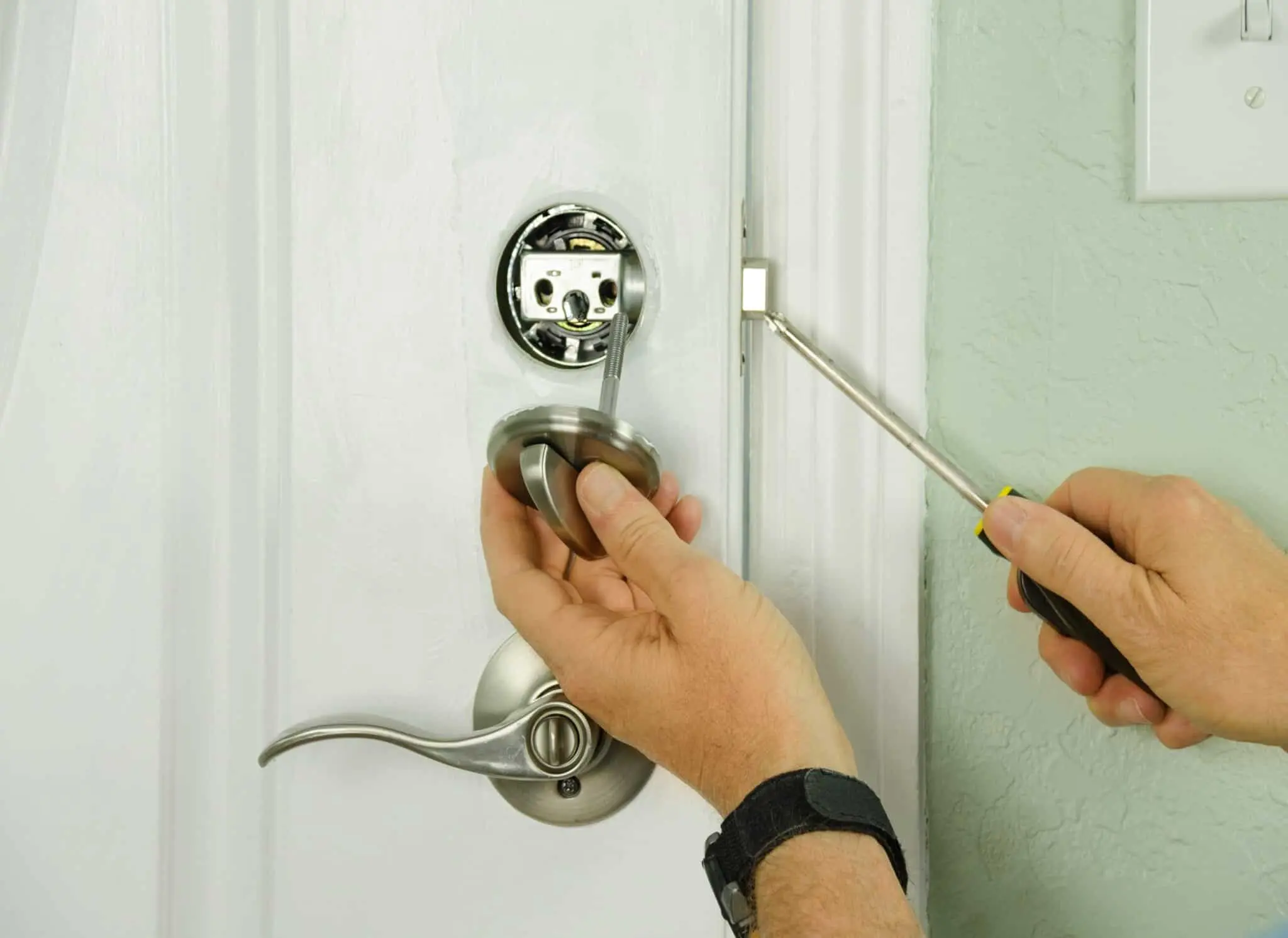 Locksmith repairing a door lock mechanism