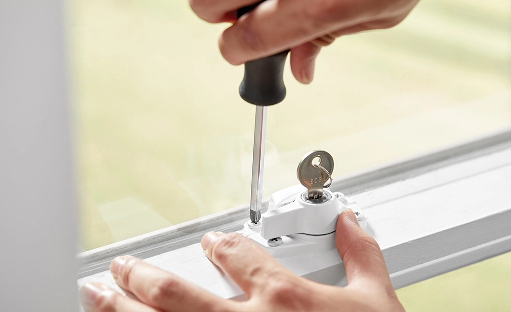 Locksmith installing secure locks on a residential window